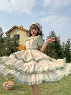 Elegant Lolita Fashionista Posing In A Vintage-inspired Garden Wallpaper