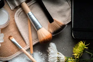 Elegant Makeup Brushesand Cosmetics Flatlay Wallpaper