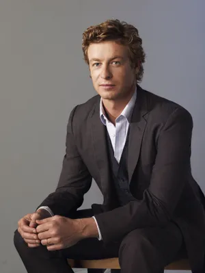 Elegant Man Seated Portrait Wallpaper