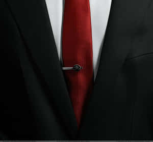 Elegant Man Wearing Luxurious Red Tie Wallpaper
