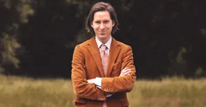 Elegant Manin Brown Suit Outdoors Wallpaper