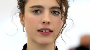 Elegant Margaret Qualley In A Vibrant Red Dress Wallpaper