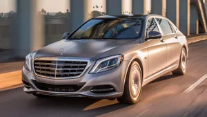 Elegant Maybach Luxury Sedan On The Road Wallpaper