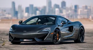 Elegant Mclaren Gt Dominating The Road Wallpaper