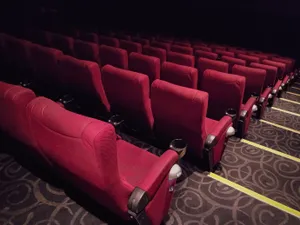 Elegant Movie Theater With Red Chairs Wallpaper