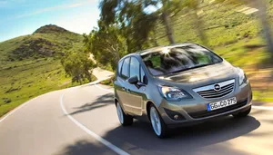 Elegant Opel Meriva In Motion On A Bright Day Wallpaper