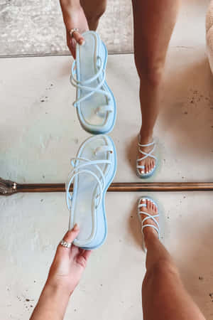 Elegant Pair Of Sandals On A Tropical Beach Wallpaper