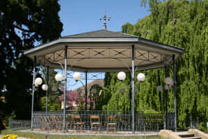 Elegant Park Bandstand Surroundedby Greenery Wallpaper