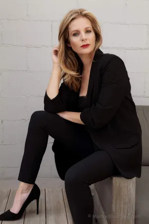 Elegant Portraitof Womanin Black Outfit Wallpaper