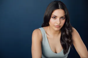 Elegant Portraitof Womanin Blue Backdrop Wallpaper