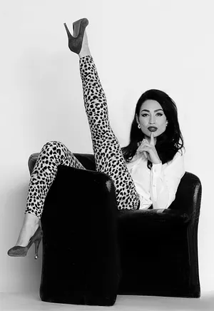 Elegant Posein Leopard Pantsand Heels Wallpaper