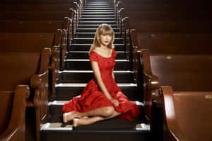 Elegant Red Dress On Stairs Wallpaper