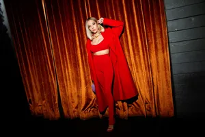 Elegant Red Ensembleat Velvet Curtain Backdrop Wallpaper