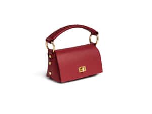 Elegant Red Handbag On A Wooden Table Wallpaper