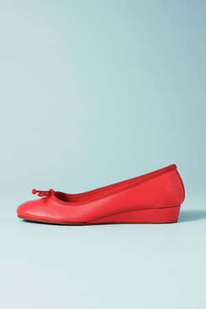 Elegant Red Stilettos On A Black Surface Wallpaper