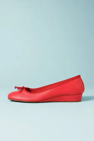 Elegant Red Stilettos On A Black Surface Wallpaper