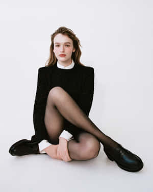 Elegant Sitting Womanin Black Dress Wallpaper