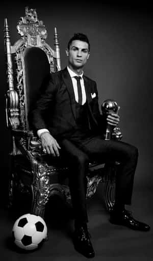 Elegant Soccer Star Throne Pose Wallpaper