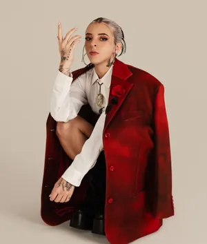 Elegant Tattooed Womanin Red Blazer Wallpaper