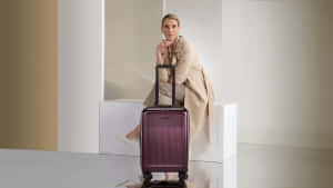 Elegant Travelerwith Purple Suitcase Wallpaper