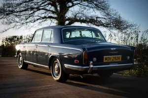 Elegant Vintage Bentley T1 On A Picturesque Ocean Road Wallpaper