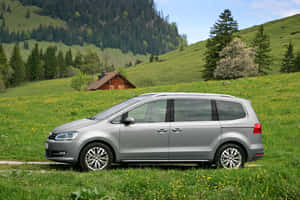 Elegant Volkswagen Sharan Gliding On The Road Wallpaper