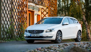 Elegant Volvo V60 Cruising On A Scenic Road Wallpaper