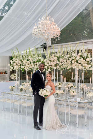 Elegant Wedding Couple Under Chandelier Wallpaper