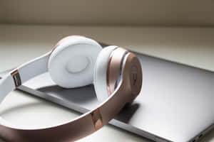 Elegant Whiteand Rose Gold Headphones Wallpaper