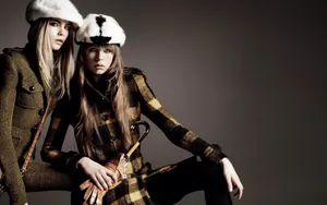 Elegant Winter Attire In Snowy Cityscape Wallpaper