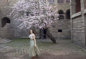 Elegant Woman Blooming Tree Courtyard Wallpaper