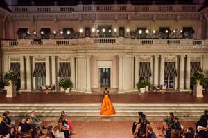 Elegant Woman In Ralph Lauren Orange Dress Wallpaper