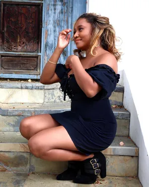 Elegant Woman Sittingon Stairs Wallpaper