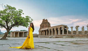 Elegant Woman Wearing A Stylish Yellow Dress Wallpaper