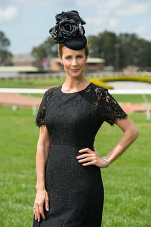 Elegant Womanin Black Dressat Racetrack Wallpaper