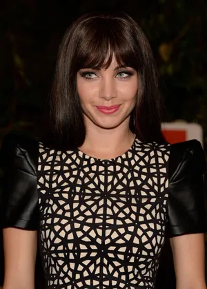 Elegant Womanin Geometric Pattern Dress Wallpaper