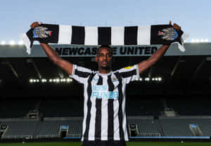 Eligible Football Player Holding A Scarf Wallpaper