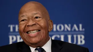 Elijah Cummings Smiling With Blue Backdrop Wallpaper