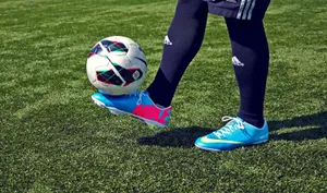 Elite Soccer Cleats Against A Scenic Backdrop Wallpaper