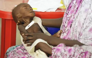 Emaciated Sleeping Child Wallpaper