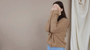 Embarrassed Woman Covering Face Wallpaper