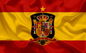 Embodying Spirit & Pride - Spain National Football Team Emblazoned Insignia Wallpaper