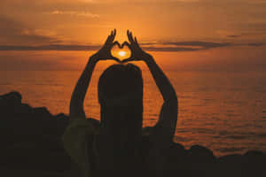 Embracing Love With A Heart Silhouette Wallpaper