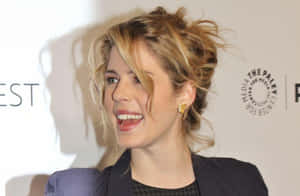 Emily Bett Rickards Smiling Event Appearance Wallpaper