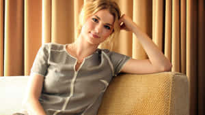 Emily Vancamp Relaxed Poseon Couch Wallpaper