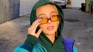 Emma Chamberlain In Green Hoodie Wallpaper
