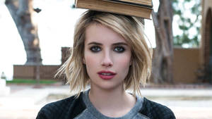 Emma Roberts Balancing A Book Wallpaper