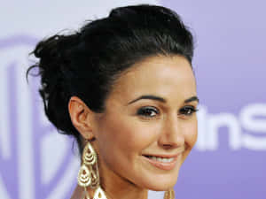 Emmanuelle Chriqui Smiling Elegantly In A Chic Dress Wallpaper