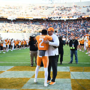 Emotional Sports Moment Taylor Hug Wallpaper