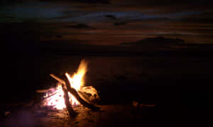 Enchanting Beach Bonfire At Sunset Wallpaper